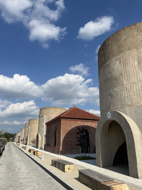 Looking east at the restored concrete sand bins and regulator houses at the southern portion of the site.