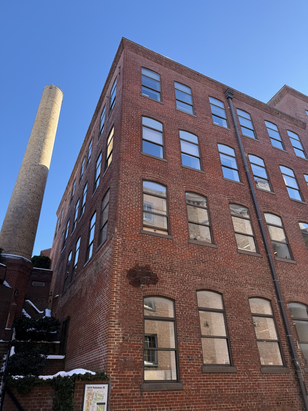 Photo of historic mill and smokestack from Potomac Street NW.